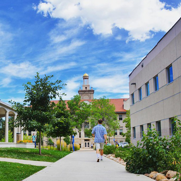 student walking through campus towards Guggenheim