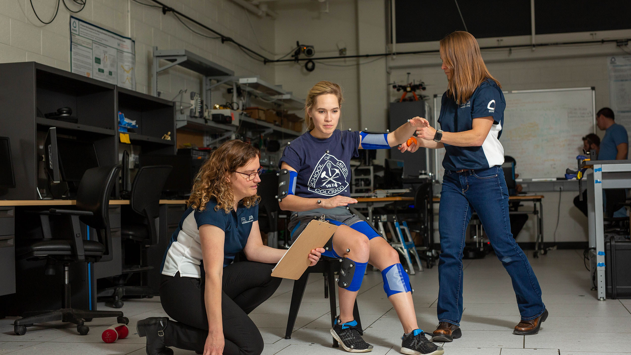 Students working on hand and leg attachments to benefit movement.