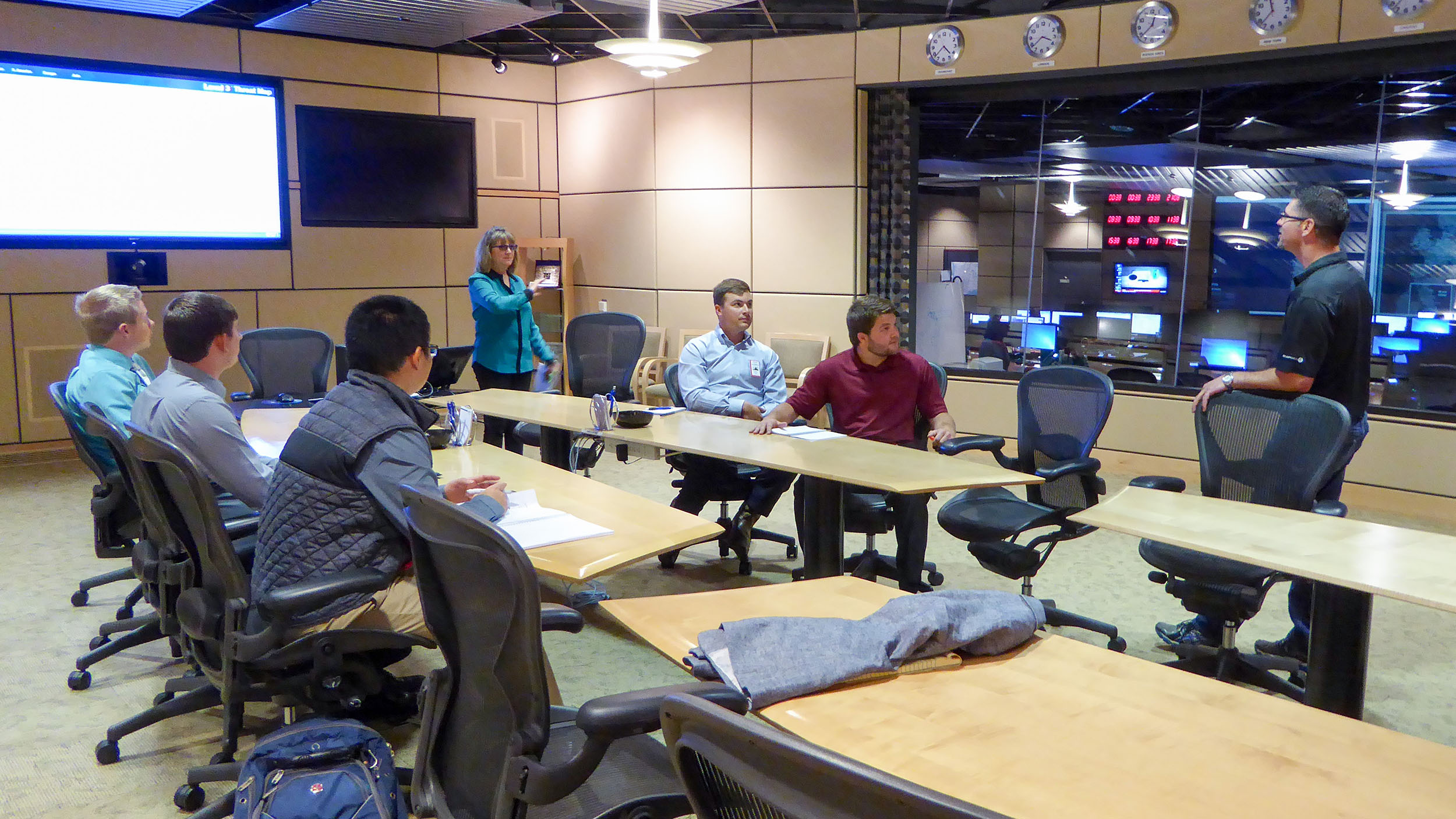 Group of economics students sitting around a meeting table