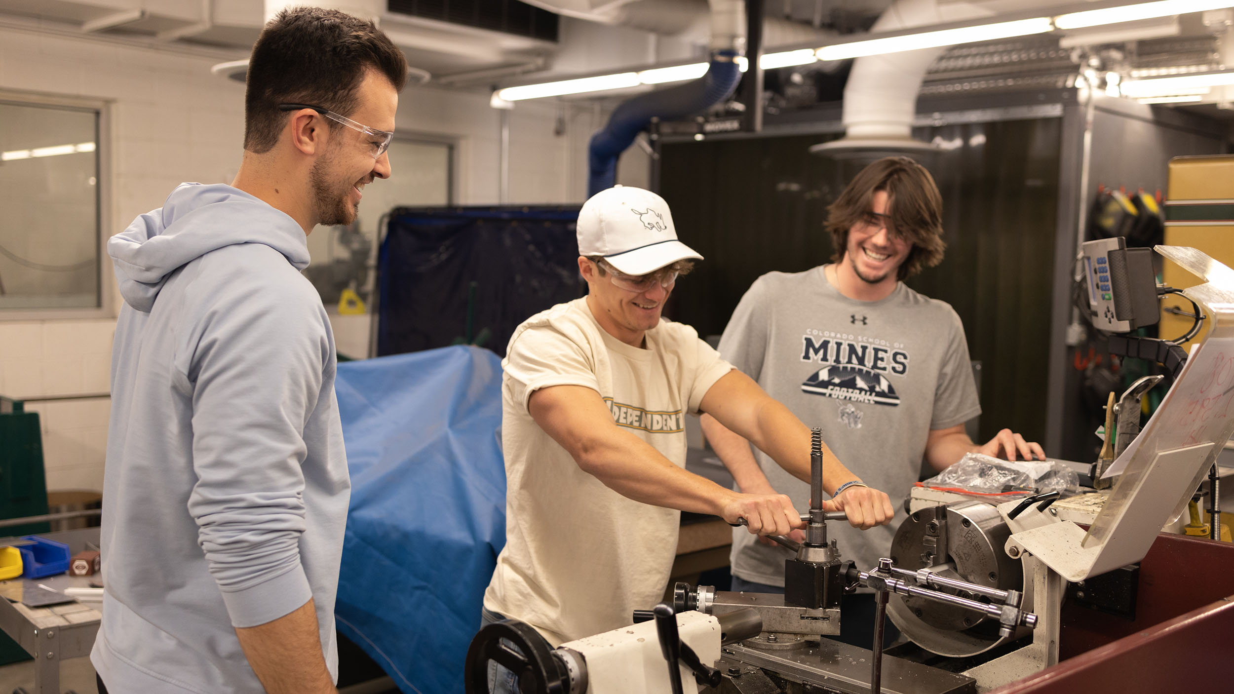 Students working with machines in the machine shop.