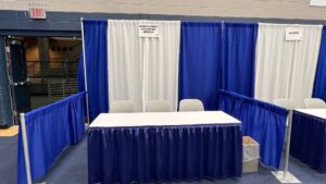 Table and chairs in a draped booth