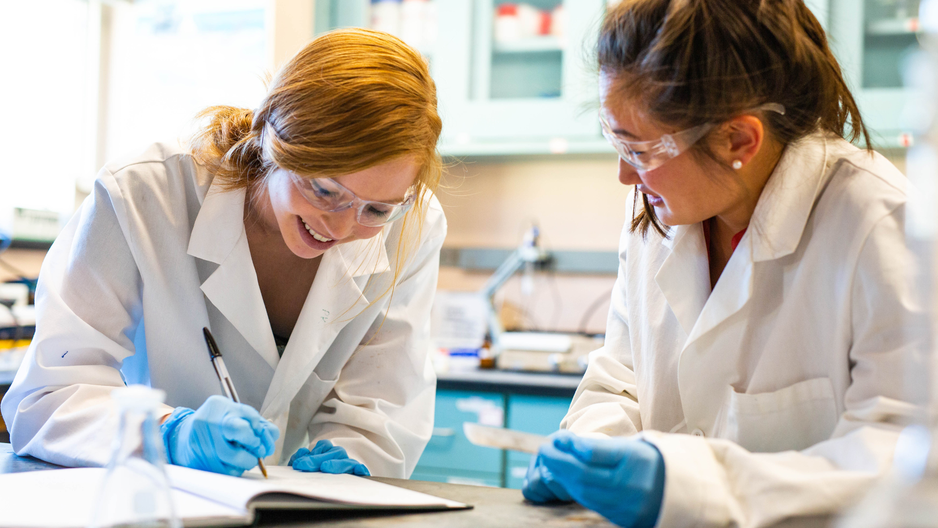 Two students do a test experiment in a chemistry lab