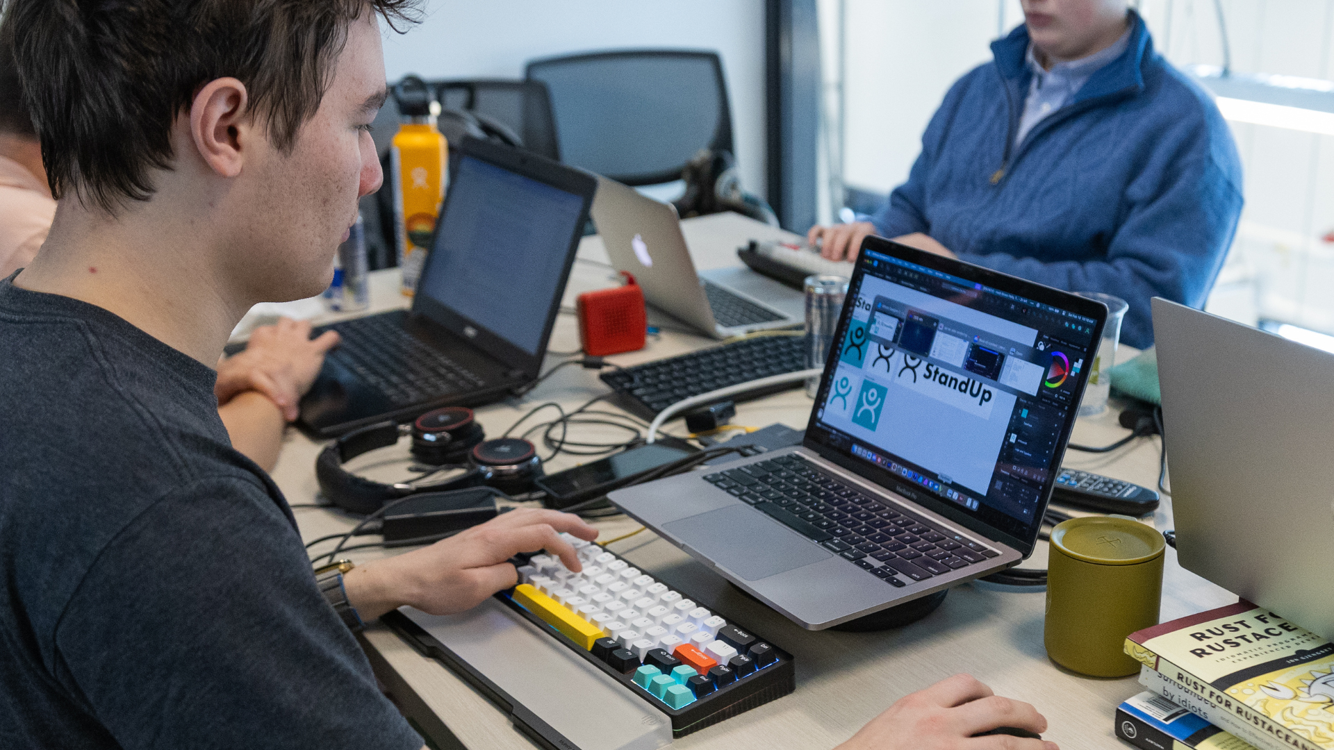 A computer science student practices coding on a laptop