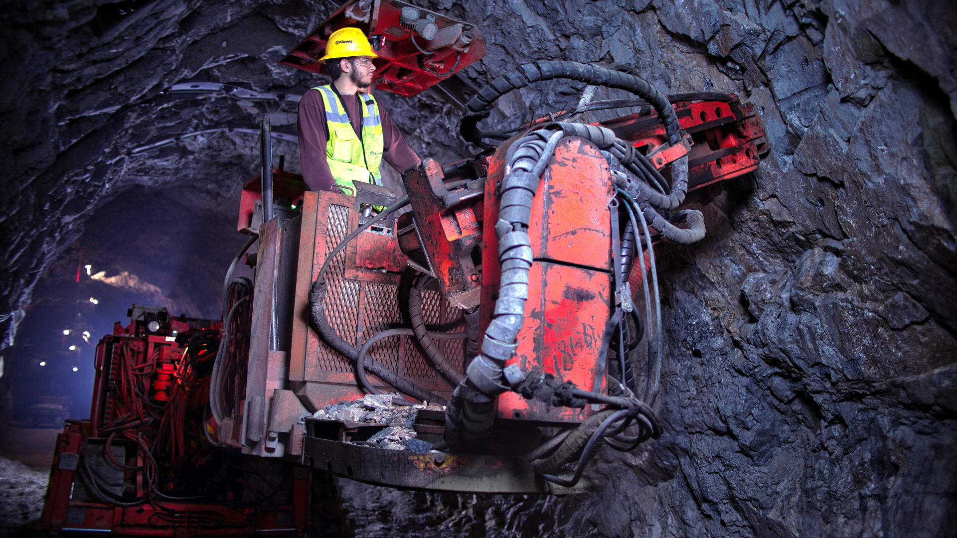 A student operates a machine in a mineshaft