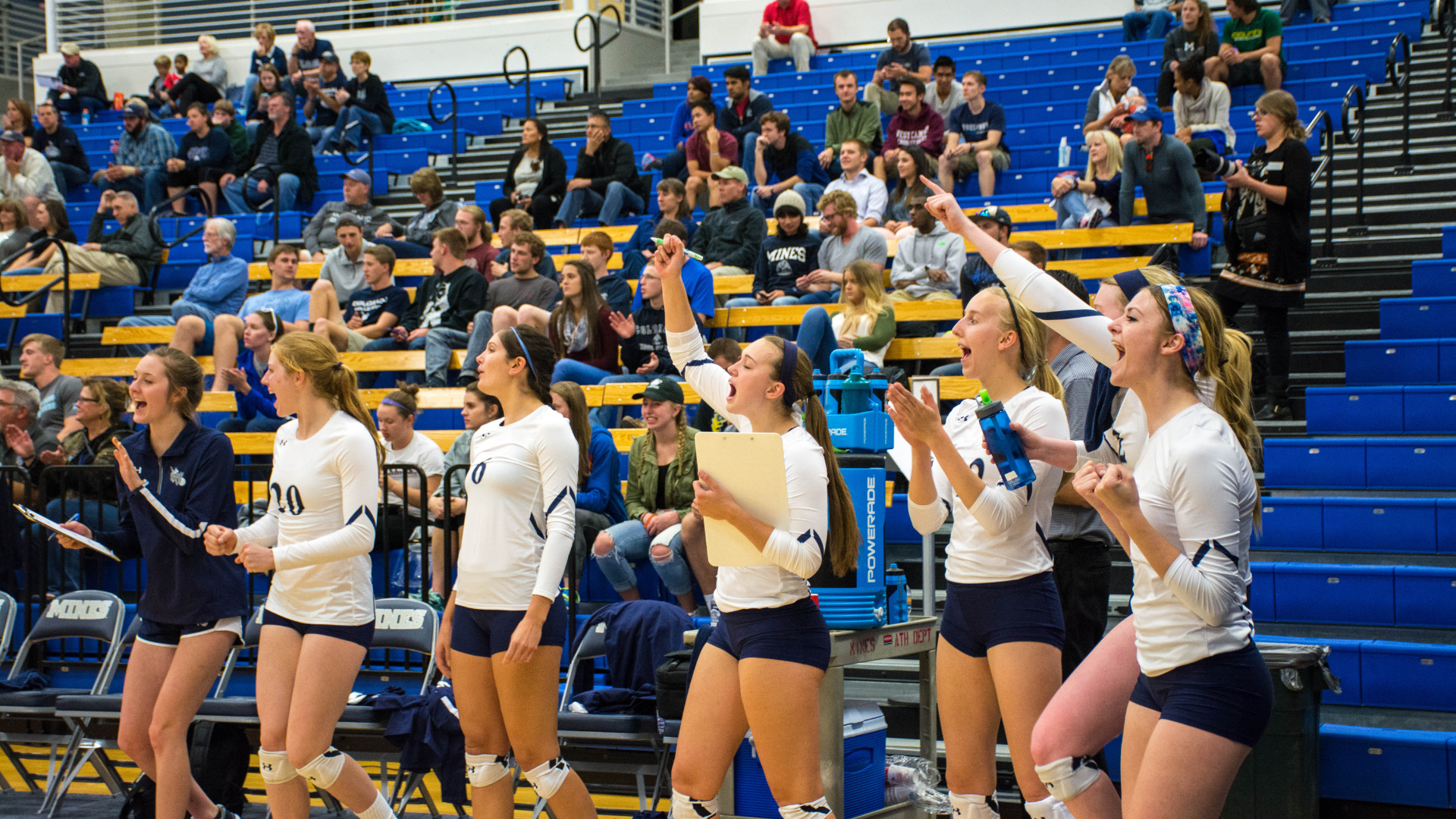 The Mines women's volleyball team cheers on their teammates