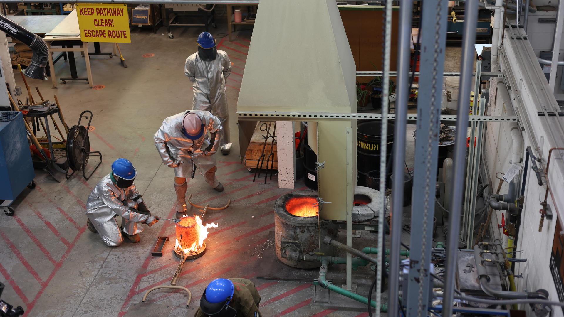 Two students make a casting in the Mines Foundry