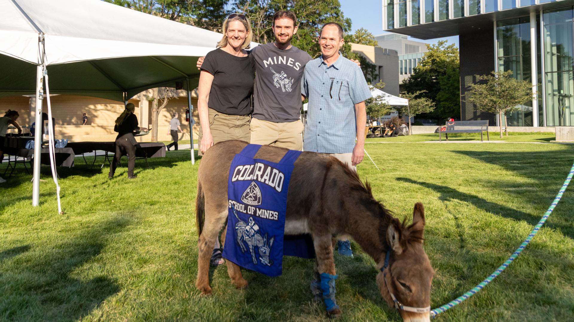 A family poses with Blaster the Burro at the first year student welcome BBQ